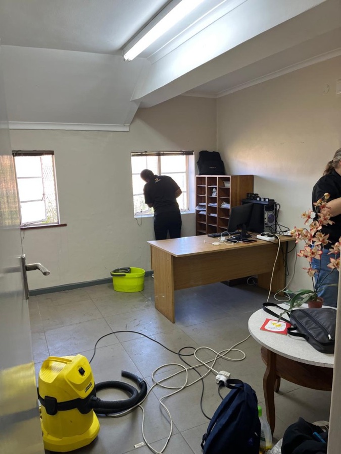 Prosec Guards team cleaning inside the SAPS satellite station office.